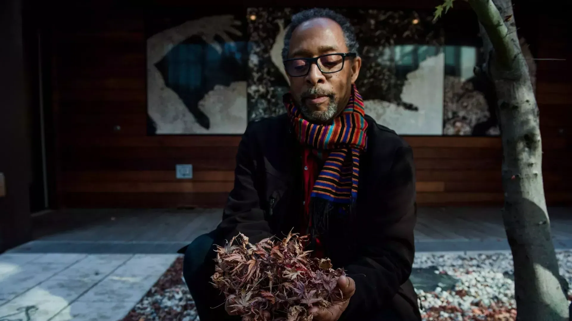 Ron Moultrie Saunders holding leaves.