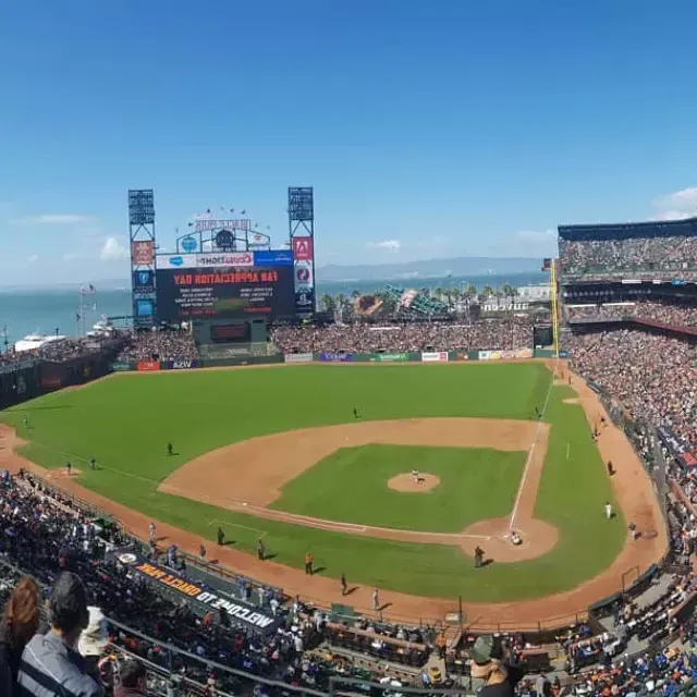 Ein Blick von der Tribüne auf den Oracle Park in San Francisco, mit dem Baseball-Diamanten im Vordergrund und der San Francisco Bay im Hintergrund.